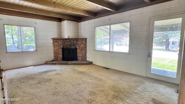 157 Cottonwood Dr, Stateline, NV 89449 - unfurnished living room with carpet flooring, concrete block wall, a fireplace, and a wood ceiling with exposed beams