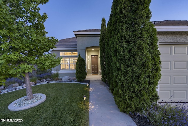 1660 Murrieta Ct, Reno, NV 89521 - view of property hidden behind natural elements with a front yard, a tiled roof, stucco siding, and an attached garage