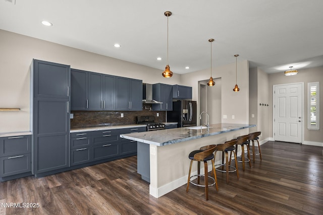 1660 Murrieta Ct, Reno, NV 89521 - kitchen with stainless steel gas range oven, refrigerator with ice dispenser, wall chimney exhaust hood, a breakfast bar area, and a peninsula