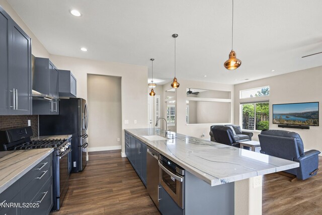 1660 Murrieta Ct, Reno, NV 89521 - kitchen featuring stainless steel appliances, open floor plan, dark wood-style floors, light stone countertops, and pendant lighting