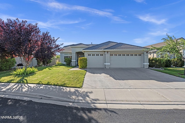 10265 Donnay Ct, Reno, NV 89521 - view of front facade featuring an attached garage, driveway, a front yard, stucco siding, and a tiled roof