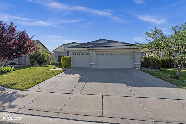 10265 Donnay Ct, Reno, NV 89521 - view of front of house featuring a garage, concrete driveway, a front yard, stucco siding, and a tiled roof