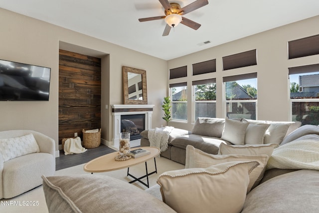 10265 Donnay Ct, Reno, NV 89521 - living room featuring ceiling fan, light wood-style flooring, and a glass covered fireplace