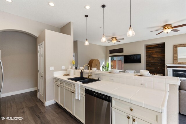 10265 Donnay Ct, Reno, NV 89521 - kitchen with stainless steel dishwasher, open floor plan, ceiling fan, a peninsula, and dark wood-style floors