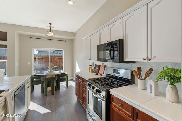 10265 Donnay Ct, Reno, NV 89521 - kitchen featuring appliances with stainless steel finishes, tile counters, backsplash, white cabinets, and dark wood finished floors
