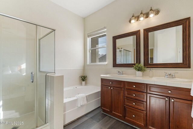 10265 Donnay Ct, Reno, NV 89521 - full bathroom featuring double vanity, a stall shower, a bath, and wood finished floors