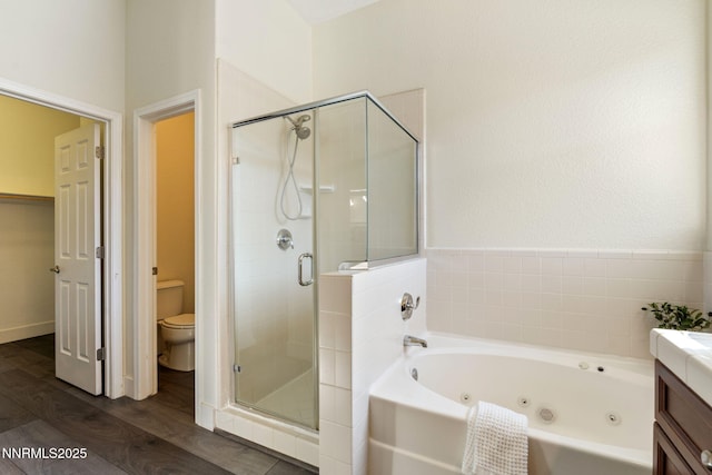 10265 Donnay Ct, Reno, NV 89521 - full bathroom with a shower stall, a jetted tub, wood finished floors, and vanity