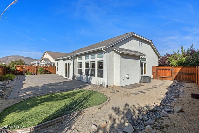 10265 Donnay Ct, Reno, NV 89521 - back of house featuring a fenced backyard, a patio area, stucco siding, and a gate