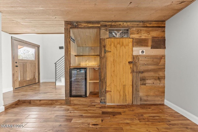 4710 Yukon Ct, Carson City, NV 89706 - foyer entrance with beverage cooler, wooden ceiling, wood finished floors, and stairway