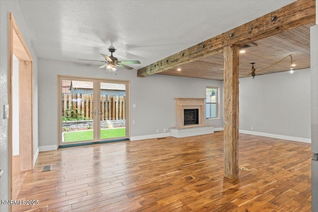 4710 Yukon Ct, Carson City, NV 89706 - unfurnished living room with a ceiling fan, wood finished floors, a high end fireplace, and a textured ceiling
