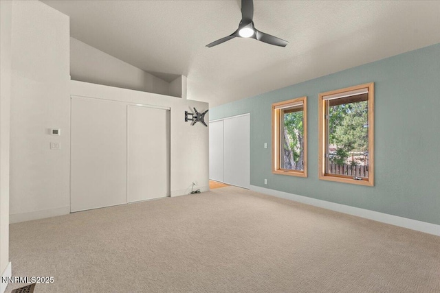4710 Yukon Ct, Carson City, NV 89706 - unfurnished bedroom featuring carpet, lofted ceiling, and a ceiling fan
