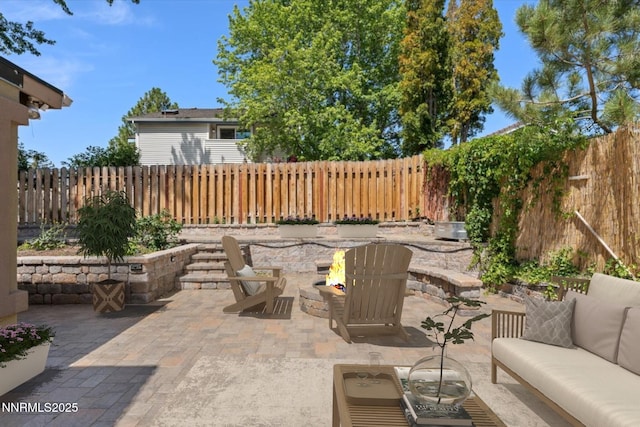 4710 Yukon Ct, Carson City, NV 89706 - fenced backyard with an outdoor living space with a fire pit and a patio