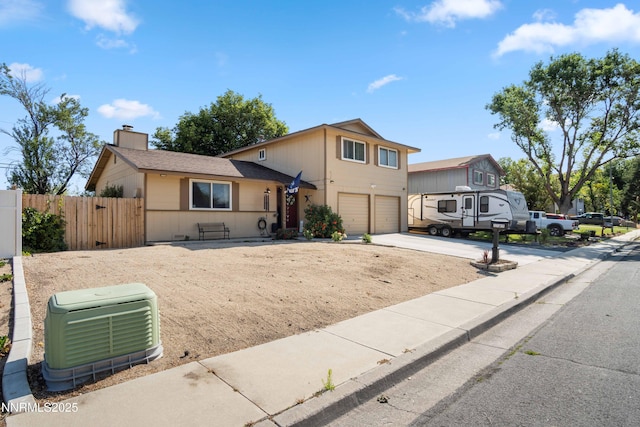 1165 Autumn Hills Dr, Reno, NV 89511 - view of front of house featuring an attached garage, concrete driveway, and a chimney