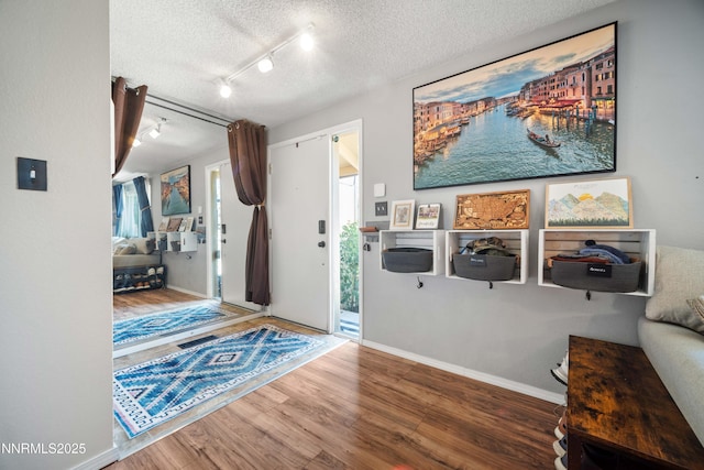 1165 Autumn Hills Dr, Reno, NV 89511 - foyer with a textured ceiling, wood finished floors, and rail lighting