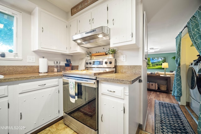 1165 Autumn Hills Dr, Reno, NV 89511 - kitchen featuring stainless steel electric range, under cabinet range hood, healthy amount of natural light, and white cabinets