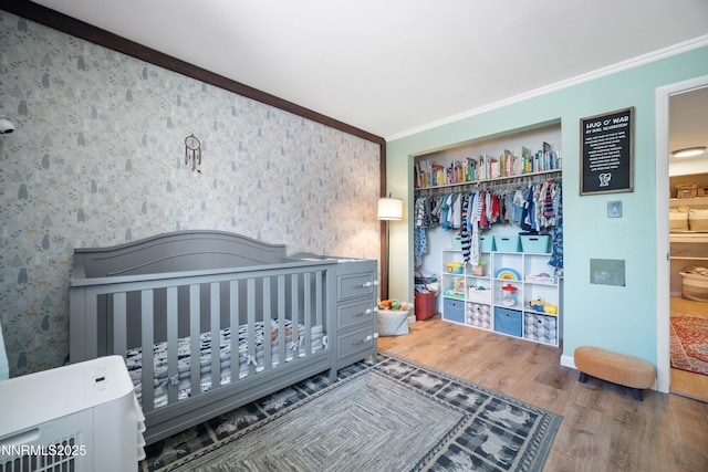 1165 Autumn Hills Dr, Reno, NV 89511 - bedroom with ornamental molding, wood finished floors, wallpapered walls, and a closet