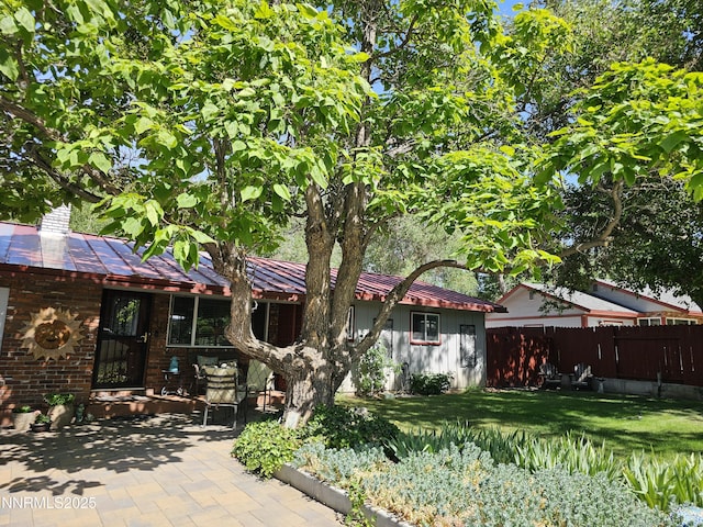 80 Strawberry Ln, Reno, NV 89509 - view of front of house with a patio, a metal roof, a standing seam roof, and a chimney