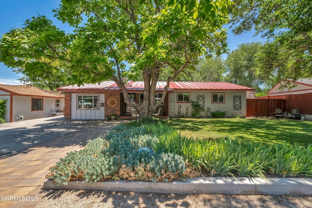 80 Strawberry Ln, Reno, NV 89509 - single story home with a metal roof, a standing seam roof, driveway, and board and batten siding