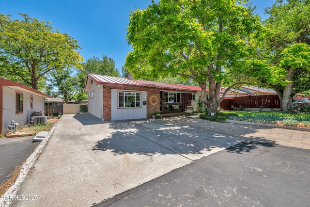 80 Strawberry Ln, Reno, NV 89509 - ranch-style house with brick siding, a standing seam roof, and a metal roof