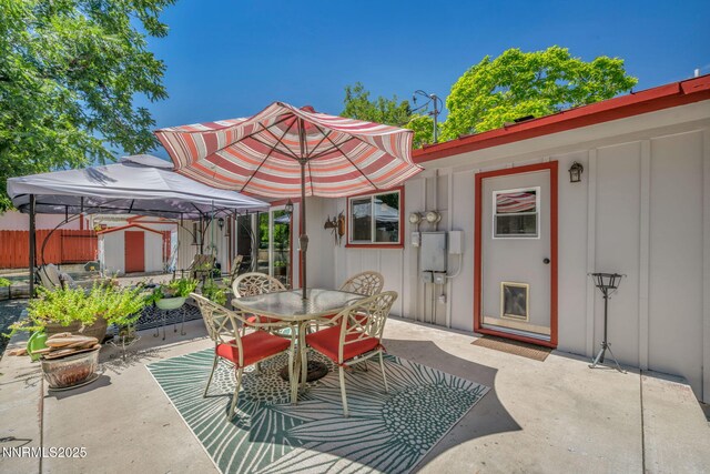 80 Strawberry Ln, Reno, NV 89509 - view of patio / terrace featuring outdoor dining space, a gazebo, and a storage unit