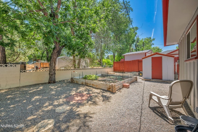 80 Strawberry Ln, Reno, NV 89509 - fenced yard with a storage shed, a garden, and a patio area