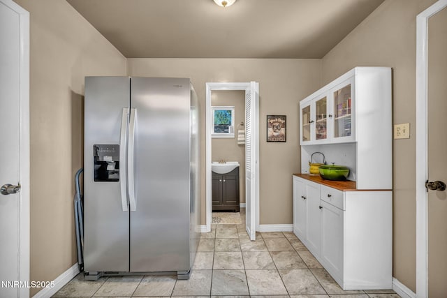 80 Strawberry Ln, Reno, NV 89509 - kitchen with stainless steel fridge with ice dispenser, white cabinetry, and glass insert cabinets