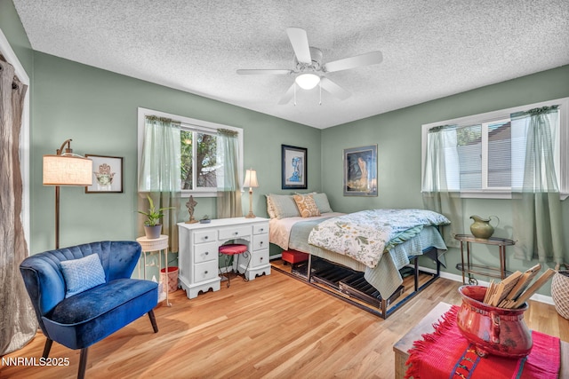 80 Strawberry Ln, Reno, NV 89509 - bedroom with wood finished floors, ceiling fan, and a textured ceiling
