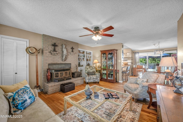 80 Strawberry Ln, Reno, NV 89509 - living room featuring a ceiling fan, wood finished floors, a textured ceiling, and a wood stove