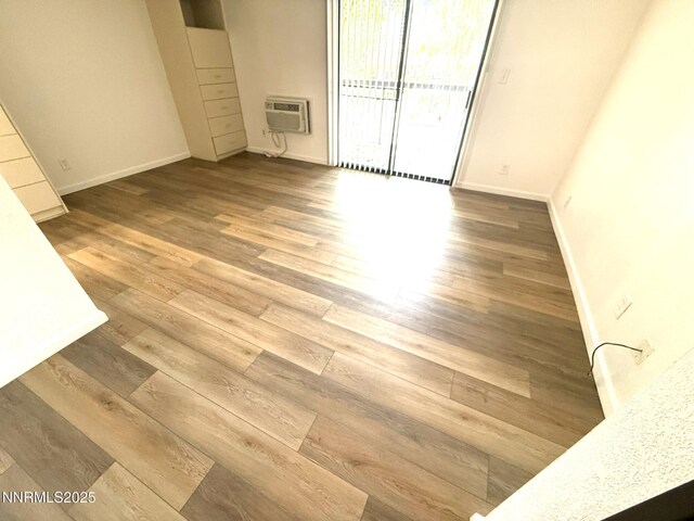 2450 Lymbery St Unit 228, Reno, NV 89509 - unfurnished room featuring wood finished floors and a wall mounted AC