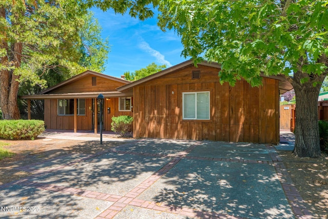908 E Robinson St, Carson City, NV 89701 - view of front facade with board and batten siding and a patio