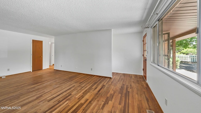 908 E Robinson St, Carson City, NV 89701 - empty room with a textured ceiling and wood finished floors