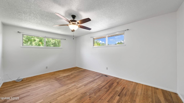 908 E Robinson St, Carson City, NV 89701 - empty room with plenty of natural light, wood finished floors, a textured ceiling, and ceiling fan