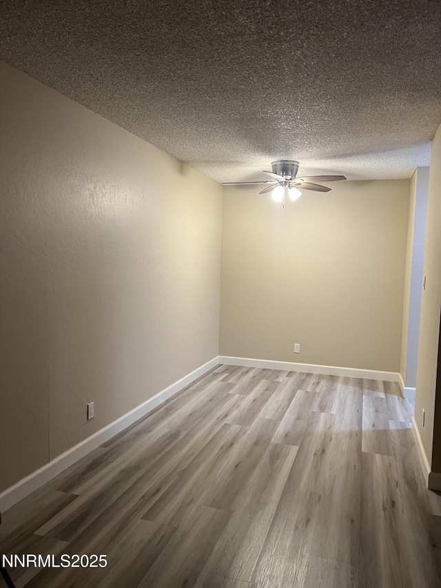2955 Lakeside Dr Unit 108, Reno, NV 89509 - empty room with a ceiling fan, wood finished floors, and a textured ceiling