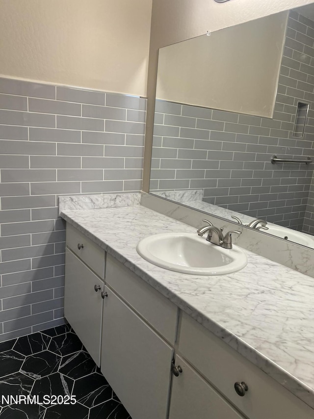 2955 Lakeside Dr Unit 108, Reno, NV 89509 - bathroom with vanity, marble look tile flooring, and tile walls