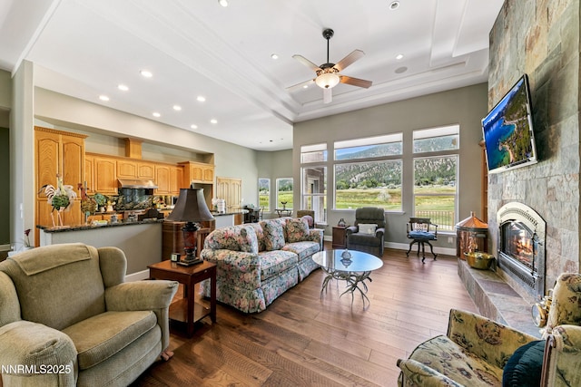 2548 Genoa Aspen Dr, Genoa, NV 89411 - living area featuring a large fireplace, dark wood finished floors, a ceiling fan, a raised ceiling, and recessed lighting