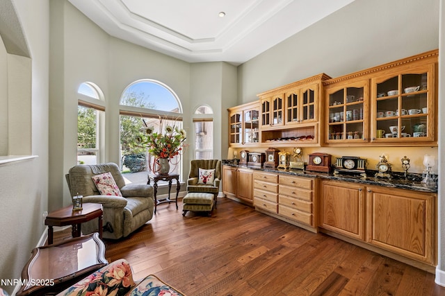2548 Genoa Aspen Dr, Genoa, NV 89411 - sitting room featuring a towering ceiling, dark wood-style floors, and a raised ceiling