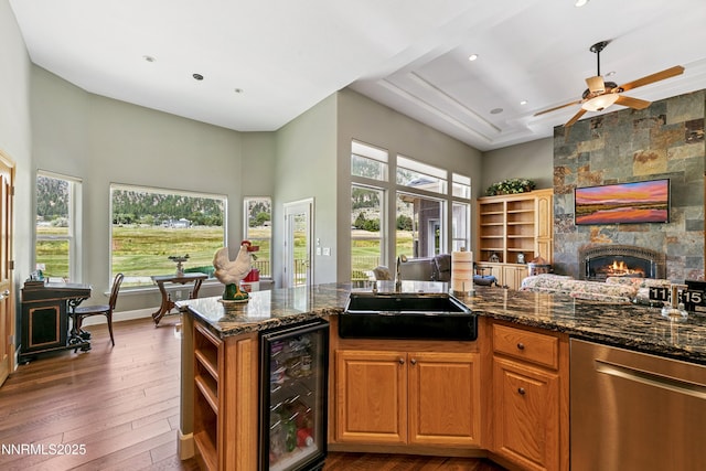 2548 Genoa Aspen Dr, Genoa, NV 89411 - kitchen featuring beverage cooler, dishwasher, a towering ceiling, open floor plan, and dark stone countertops