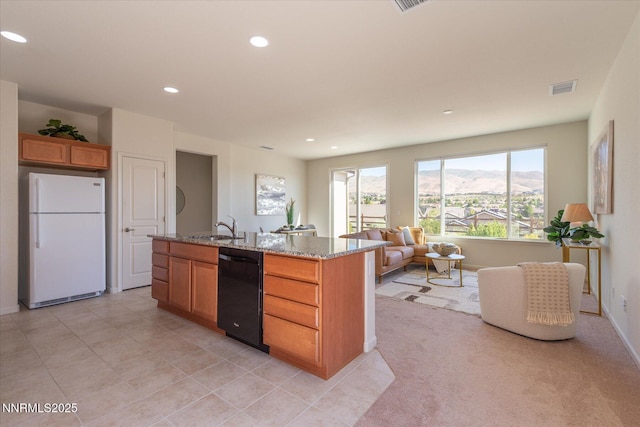 1160 Sugar Creek Trl, Reno, NV 89523 - kitchen featuring freestanding refrigerator, dishwasher, light stone countertops, recessed lighting, and a kitchen island with sink