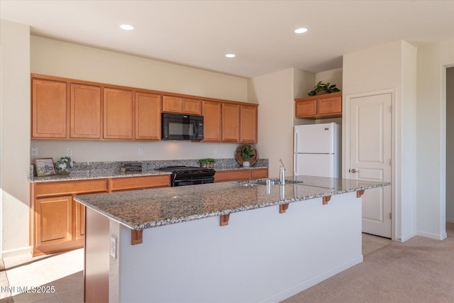 1160 Sugar Creek Trl, Reno, NV 89523 - kitchen with black appliances, a kitchen breakfast bar, stone counters, brown cabinets, and recessed lighting