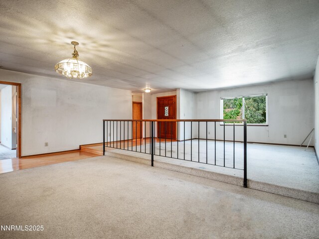1561 Alba Vis, Gardnerville, NV 89410 - carpeted empty room featuring a chandelier and a textured ceiling
