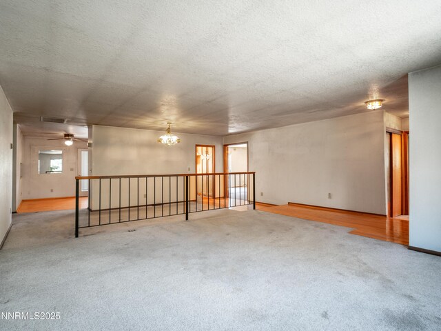1561 Alba Vis, Gardnerville, NV 89410 - unfurnished room with a textured ceiling, carpet flooring, a chandelier, and ceiling fan