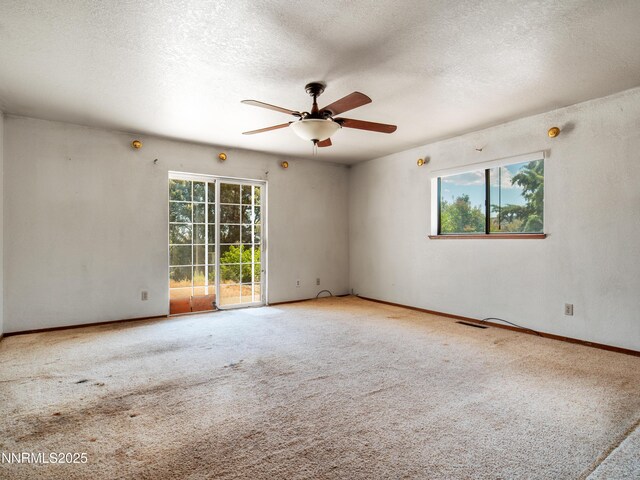 1561 Alba Vis, Gardnerville, NV 89410 - carpeted empty room featuring healthy amount of natural light, a ceiling fan, and a textured ceiling