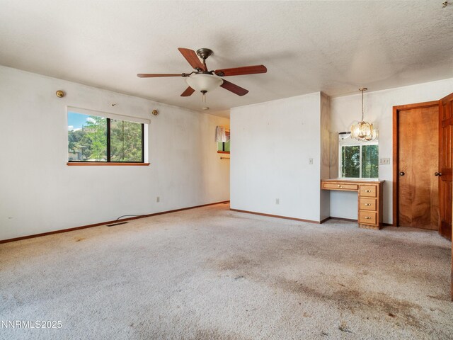 1561 Alba Vis, Gardnerville, NV 89410 - unfurnished living room with carpet floors, ceiling fan, a desk, and a chandelier