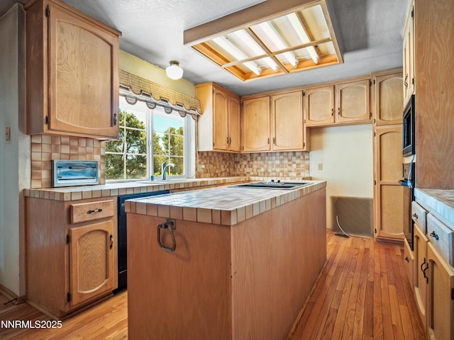 1561 Alba Vis, Gardnerville, NV 89410 - kitchen with tile countertops, light wood-style floors, and decorative backsplash