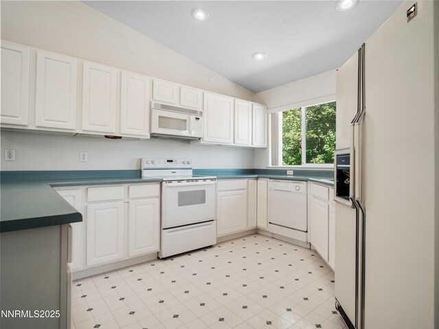 1561 Alba Vis, Gardnerville, NV 89410 - kitchen featuring white appliances, lofted ceiling, recessed lighting, white cabinetry, and dark countertops