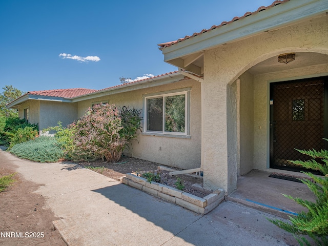 1561 Alba Vis, Gardnerville, NV 89410 - entrance to property featuring stucco siding, a tiled roof, and a patio
