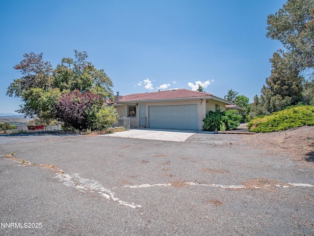 1561 Alba Vis, Gardnerville, NV 89410 - view of front of home with a tile roof, stucco siding, a garage, and driveway