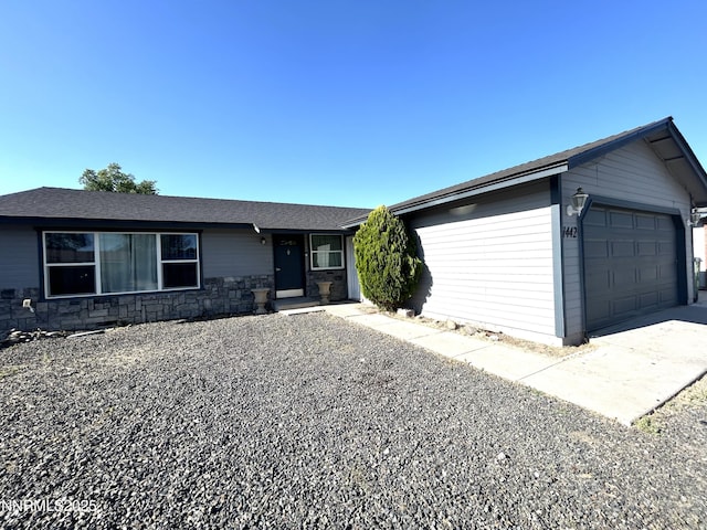 1442 Spooner Dr, Carson City, NV 89706 - ranch-style house featuring a garage, stone siding, and driveway