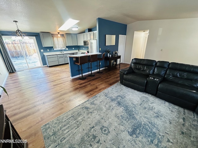 1442 Spooner Dr, Carson City, NV 89706 - living area featuring lofted ceiling, wood finished floors, and a chandelier