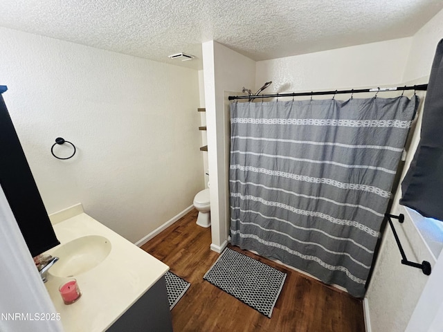 1442 Spooner Dr, Carson City, NV 89706 - bathroom with wood finished floors, a textured ceiling, vanity, a shower with curtain, and a textured wall